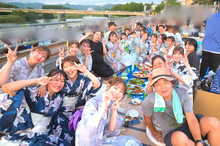 浴衣姿で集まり、みんなで食事をするスタッフたち